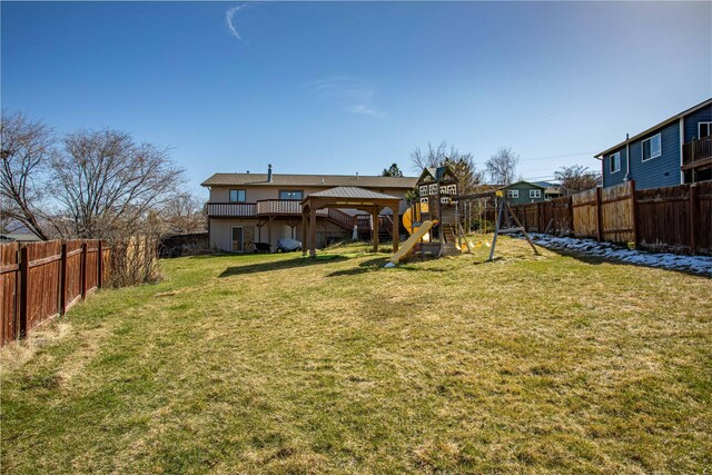 view of yard with a fenced backyard and a playground