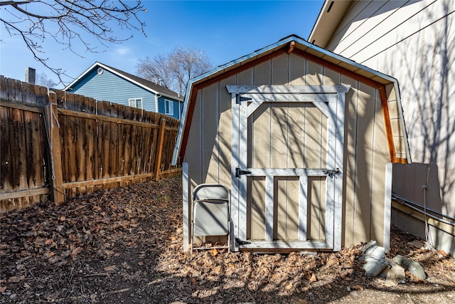 view of shed featuring fence