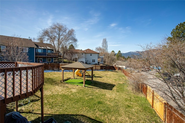 view of yard with a gazebo, a deck with mountain view, and fence