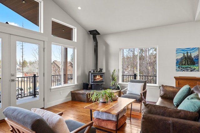304 Stumptown Loop, Whitefish, MT 59937 - living room with wood finished floors, a wood stove, recessed lighting, and high vaulted ceiling