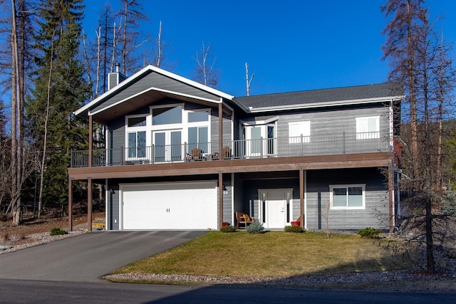 304 Stumptown Loop, Whitefish, MT 59937 - view of front of property featuring a front lawn, a chimney, a garage, driveway, and french doors