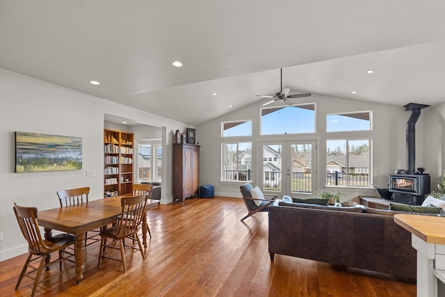 304 Stumptown Loop, Whitefish, MT 59937 - dining room with a wood stove, wood finished floors, ceiling fan, vaulted ceiling, and french doors