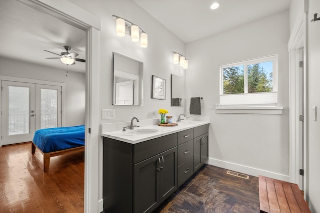 304 Stumptown Loop, Whitefish, MT 59937 - bathroom with double vanity, french doors, connected bathroom, ceiling fan, and wood finished floors
