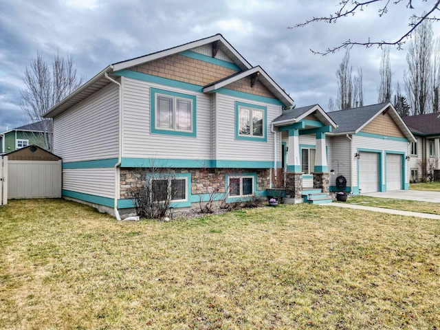 425 Northridge Dr, Kalispell, MT 59901 - split level home featuring stone siding, a garage, fence, concrete driveway, and a front lawn