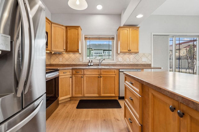 425 Northridge Dr, Kalispell, MT 59901 - kitchen with a sink, backsplash, light wood-style flooring, and appliances with stainless steel finishes