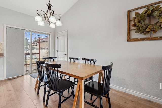 425 Northridge Dr, Kalispell, MT 59901 - dining room with visible vents, baseboards, light wood-type flooring, a chandelier, and lofted ceiling