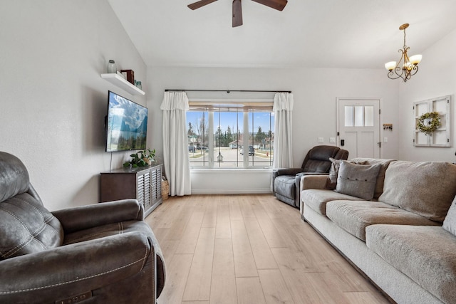 425 Northridge Dr, Kalispell, MT 59901 - living area featuring light wood-style flooring, vaulted ceiling, and ceiling fan with notable chandelier