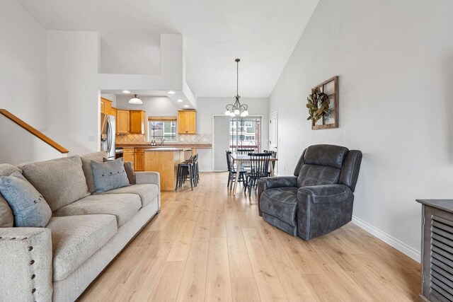 425 Northridge Dr, Kalispell, MT 59901 - living area featuring high vaulted ceiling, light wood-type flooring, recessed lighting, a chandelier, and baseboards