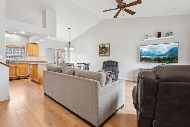 425 Northridge Dr, Kalispell, MT 59901 - living area with a healthy amount of sunlight, baseboards, light wood-style floors, and ceiling fan with notable chandelier