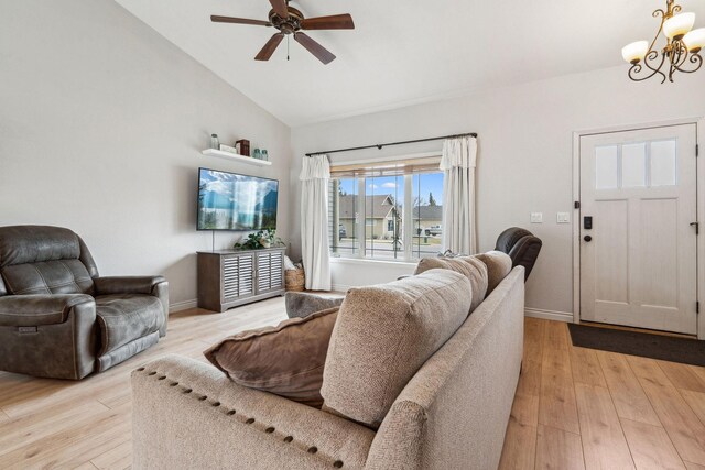 425 Northridge Dr, Kalispell, MT 59901 - living area featuring baseboards, lofted ceiling, light wood-style floors, and ceiling fan with notable chandelier