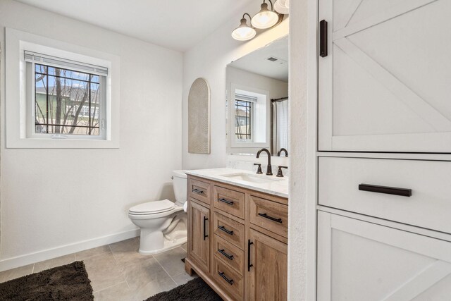 425 Northridge Dr, Kalispell, MT 59901 - bathroom featuring toilet, a wealth of natural light, baseboards, and vanity