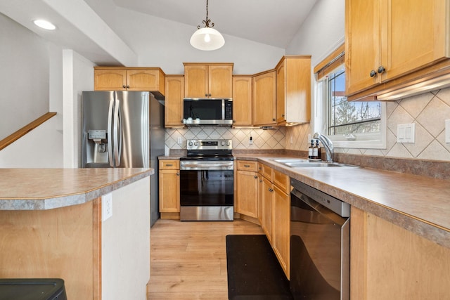 425 Northridge Dr, Kalispell, MT 59901 - kitchen featuring light wood-style floors, pendant lighting, appliances with stainless steel finishes, a sink, and lofted ceiling