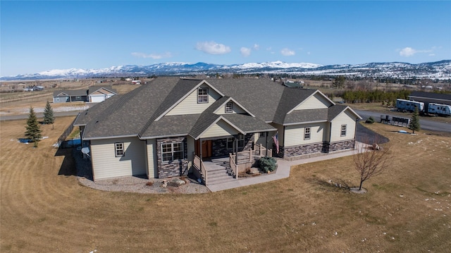 2160 Crested Wheat Loop, East Helena, MT 59635 - craftsman-style home with a front yard, stone siding, a mountain view, and a shingled roof