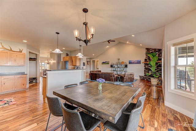 2160 Crested Wheat Loop, East Helena, MT 59635 - dining room featuring ceiling fan with notable chandelier, light wood-style flooring, baseboards, and lofted ceiling