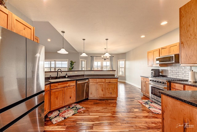2160 Crested Wheat Loop, East Helena, MT 59635 - kitchen with a peninsula, dark wood-style flooring, a sink, stainless steel appliances, and backsplash