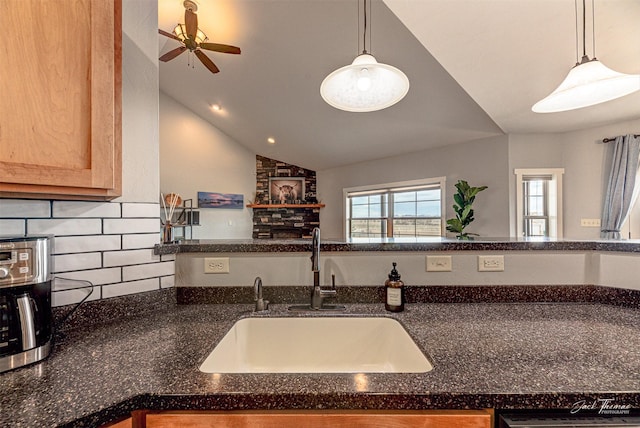 2160 Crested Wheat Loop, East Helena, MT 59635 - kitchen with a sink, ceiling fan, dark stone counters, decorative backsplash, and lofted ceiling