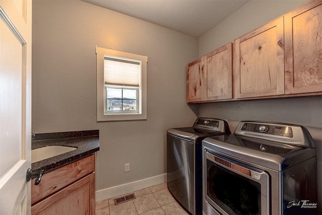 2160 Crested Wheat Loop, East Helena, MT 59635 - washroom with baseboards, a sink, cabinet space, washer and clothes dryer, and light tile patterned flooring