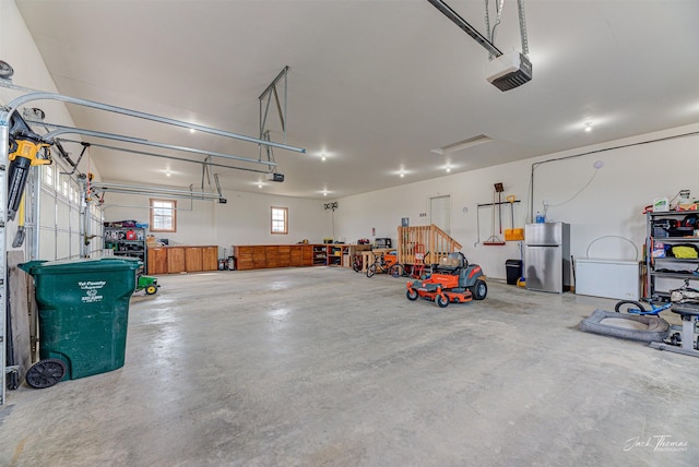 2160 Crested Wheat Loop, East Helena, MT 59635 - garage featuring freestanding refrigerator and a garage door opener