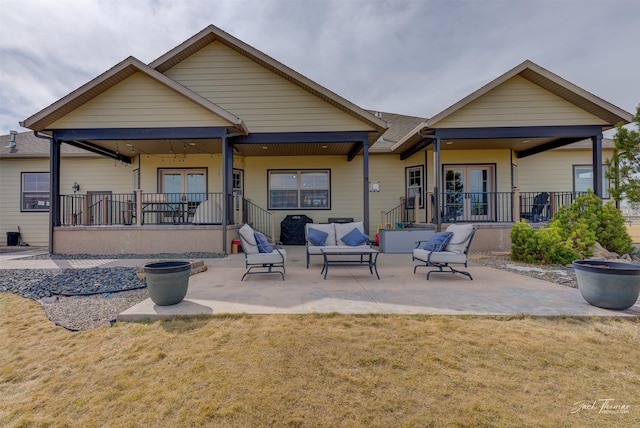 2160 Crested Wheat Loop, East Helena, MT 59635 - back of property featuring french doors, a patio area, a porch, an outdoor hangout area, and a lawn