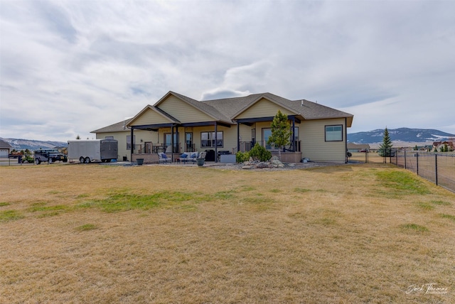 2160 Crested Wheat Loop, East Helena, MT 59635 - back of property with fence, a patio, a mountain view, and a lawn