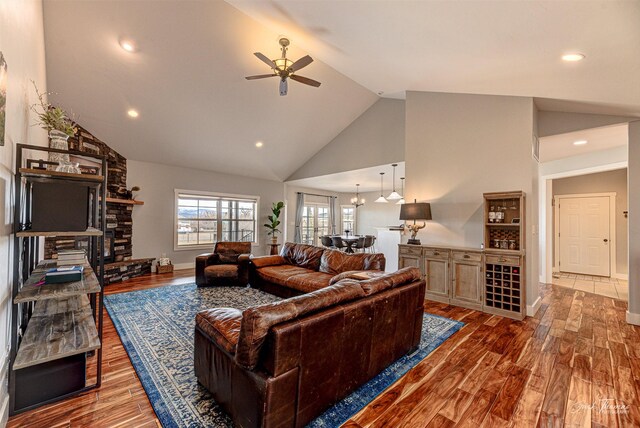 2160 Crested Wheat Loop, East Helena, MT 59635 - living area featuring ceiling fan with notable chandelier, high vaulted ceiling, recessed lighting, wood finished floors, and baseboards