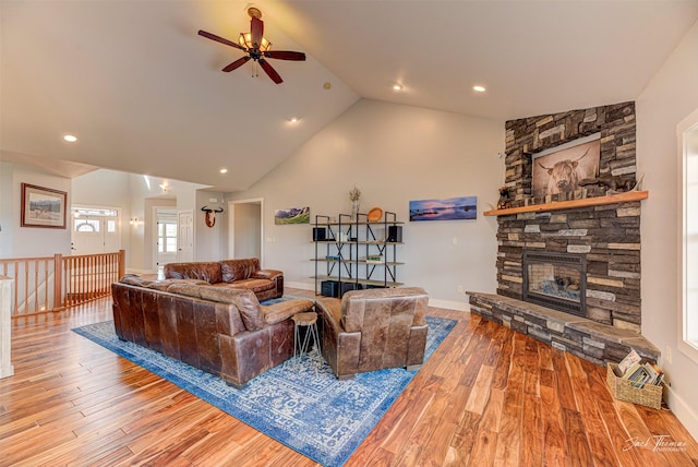 2160 Crested Wheat Loop, East Helena, MT 59635 - living room featuring baseboards, a ceiling fan, a fireplace, wood finished floors, and high vaulted ceiling