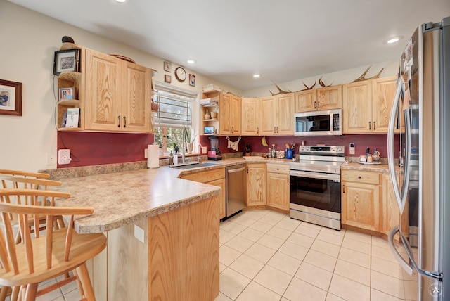 24 Spruce Grove Rd, East Helena, MT 59635 - kitchen with appliances with stainless steel finishes, open shelves, light brown cabinetry, a peninsula, and recessed lighting