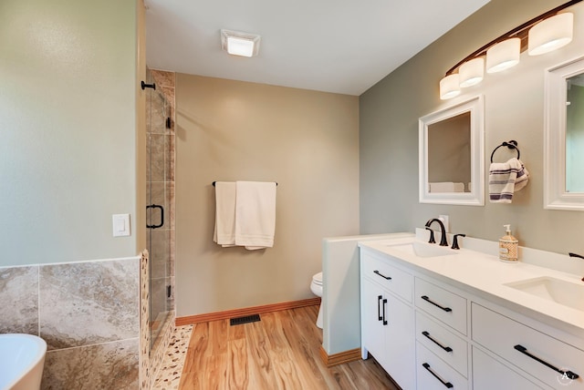 24 Spruce Grove Rd, East Helena, MT 59635 - bathroom with double vanity, a stall shower, a soaking tub, and wood finished floors