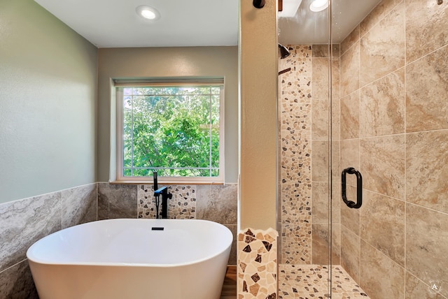 24 Spruce Grove Rd, East Helena, MT 59635 - bathroom with a freestanding bath, a stall shower, recessed lighting, and tile walls