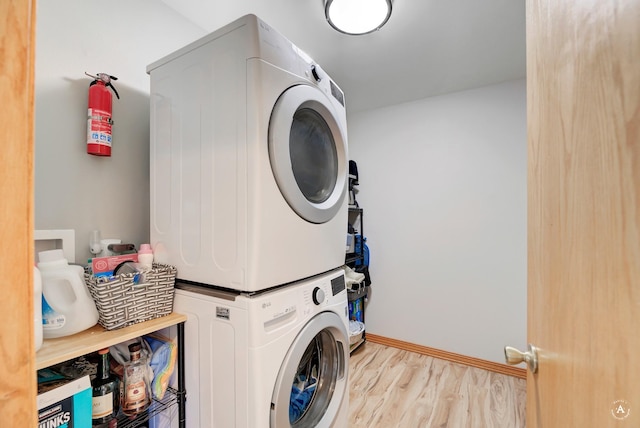 24 Spruce Grove Rd, East Helena, MT 59635 - washroom featuring stacked washing machine and dryer and wood finished floors