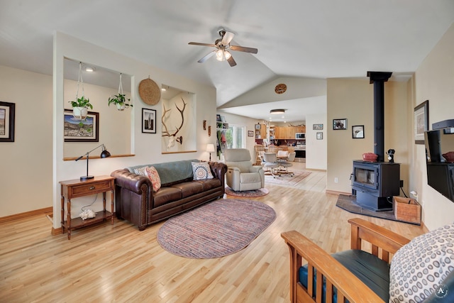 24 Spruce Grove Rd, East Helena, MT 59635 - living area with a ceiling fan, wood finished floors, a wood stove, and vaulted ceiling