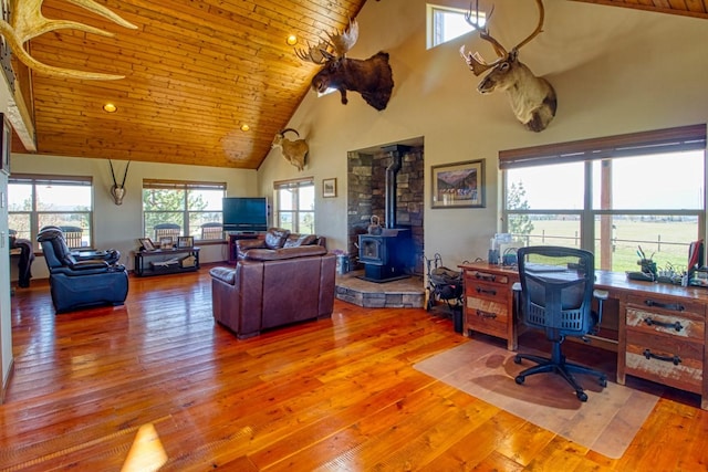1030 S Sunset Bench Rd, Stevensville, MT 59870 - living area featuring high vaulted ceiling, a wood stove, wood-type flooring, wood ceiling, and an office area