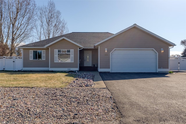 675 Pebble Dr, Kalispell, MT 59901 - single story home with asphalt driveway, an attached garage, and a shingled roof