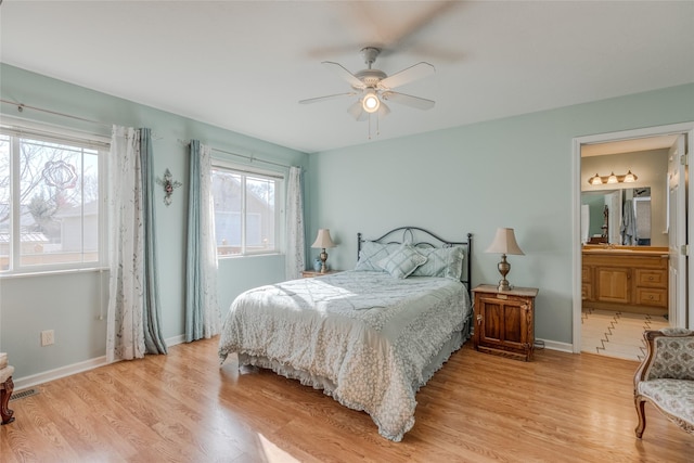 675 Pebble Dr, Kalispell, MT 59901 - bedroom with light wood finished floors, ceiling fan, and connected bathroom