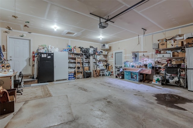 675 Pebble Dr, Kalispell, MT 59901 - garage featuring a garage door opener and a workshop area