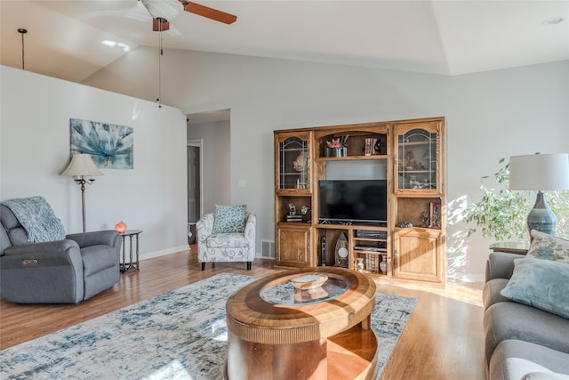 675 Pebble Dr, Kalispell, MT 59901 - living area with lofted ceiling, a ceiling fan, and wood finished floors
