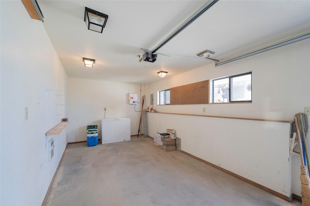 521 Clarke St, Helena, MT 59601 - garage featuring a garage door opener, fridge, and baseboards