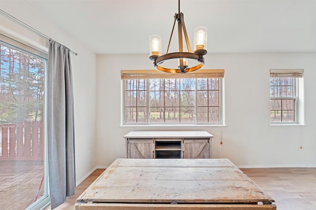 100 Forest Ridge Dr Unit B, Whitefish, MT 59937 - dining room featuring light wood-type flooring, baseboards, and a chandelier