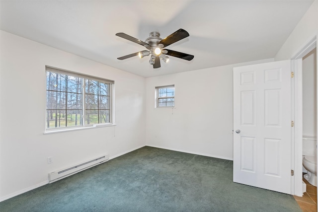 100 Forest Ridge Dr Unit B, Whitefish, MT 59937 - unfurnished bedroom featuring a baseboard radiator, dark carpet, a ceiling fan, and baseboards