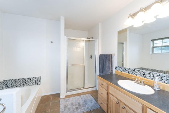 100 Forest Ridge Dr Unit B, Whitefish, MT 59937 - full bath with a shower stall, tile patterned floors, decorative backsplash, and vanity