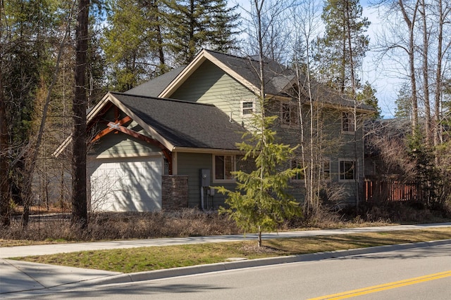 100 Forest Ridge Dr Unit B, Whitefish, MT 59937 - view of front of house with roof with shingles and a garage