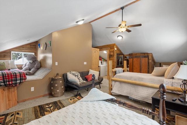 4695 Star Meadow Rd, Whitefish, MT 59937 - bedroom featuring lofted ceiling, carpet floors, wooden walls, a ceiling fan, and washer / dryer