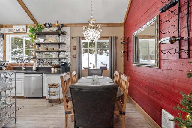 4695 Star Meadow Rd, Whitefish, MT 59937 - dining space with wood walls, a chandelier, light wood finished floors, and beam ceiling