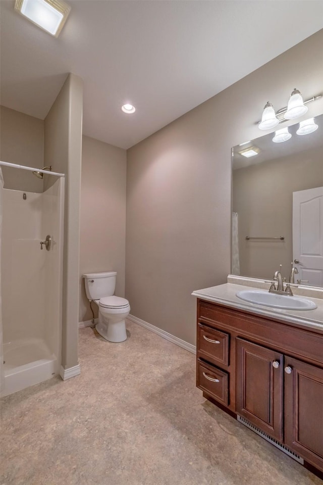 bathroom featuring baseboards, walk in shower, vanity, and toilet