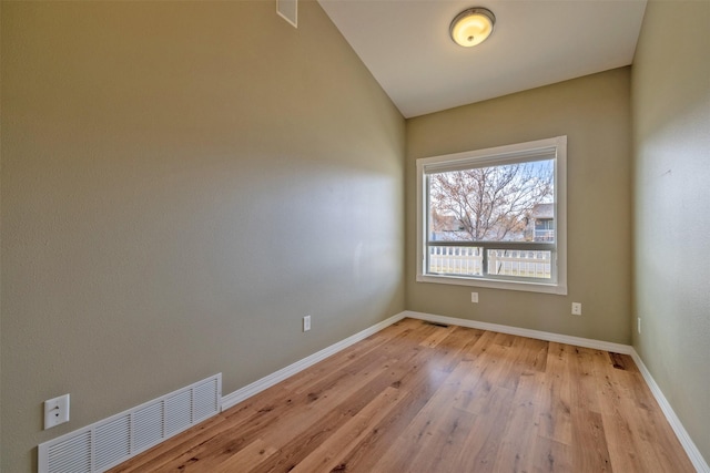 unfurnished room with baseboards, light wood finished floors, and visible vents
