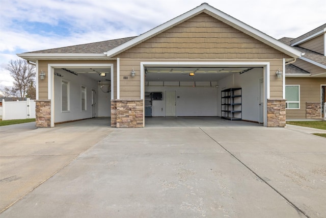 garage featuring concrete driveway