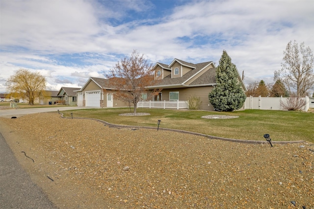 view of front of property with concrete driveway, a front lawn, fence, a porch, and a garage