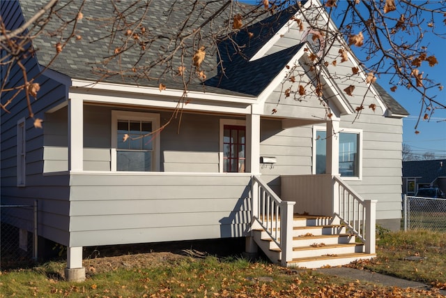 277 1st Ave, Kalispell, MT 59901 - view of front of home with roof with shingles, fence, and covered porch
