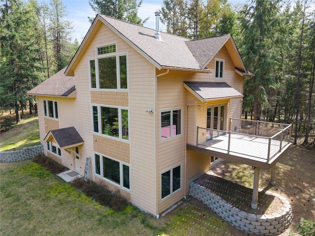 69 Fir Dr, Thompson Falls, MT 59873 - back of house with a lawn, a wooden deck, and roof with shingles