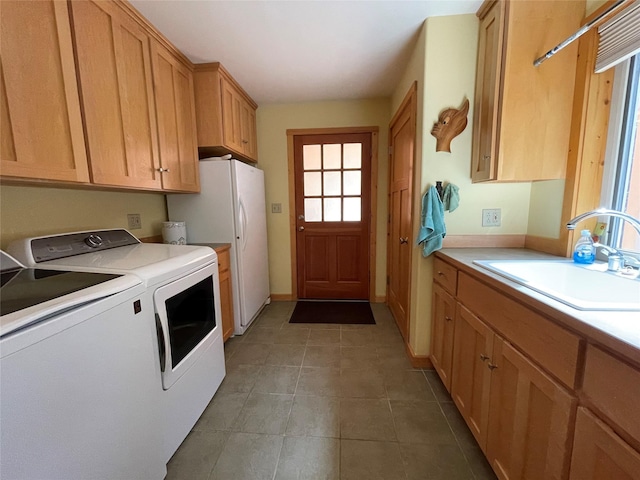 69 Fir Dr, Thompson Falls, MT 59873 - laundry room featuring washing machine and dryer, cabinet space, light tile patterned flooring, and a sink